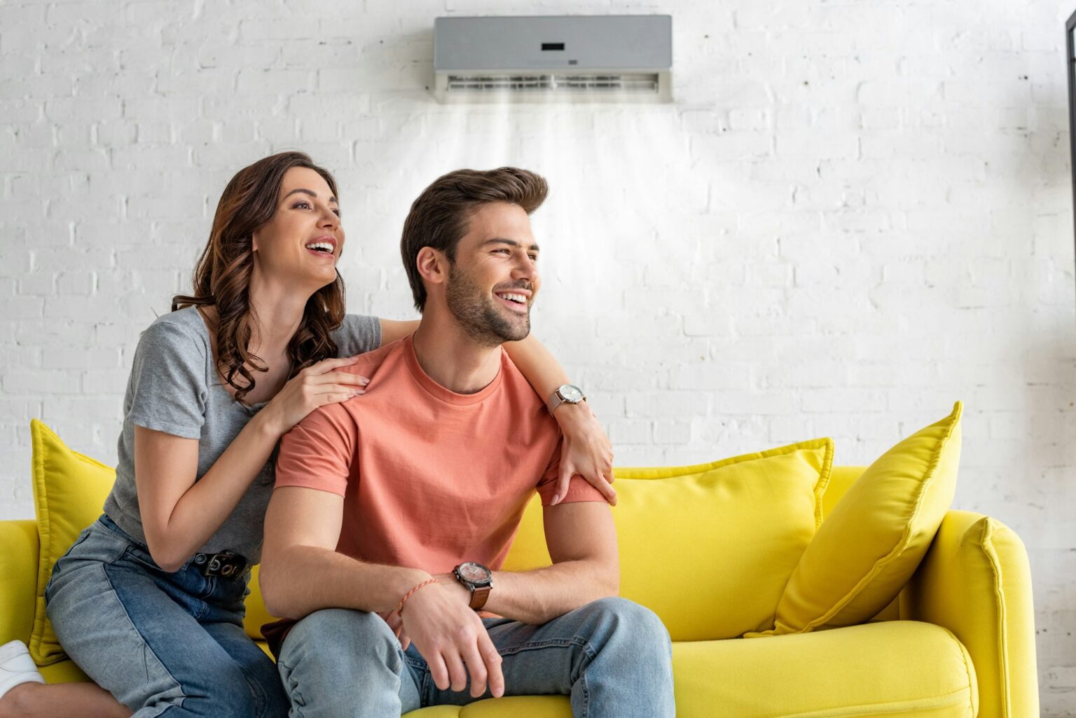 Family relaxing under an air conditioner